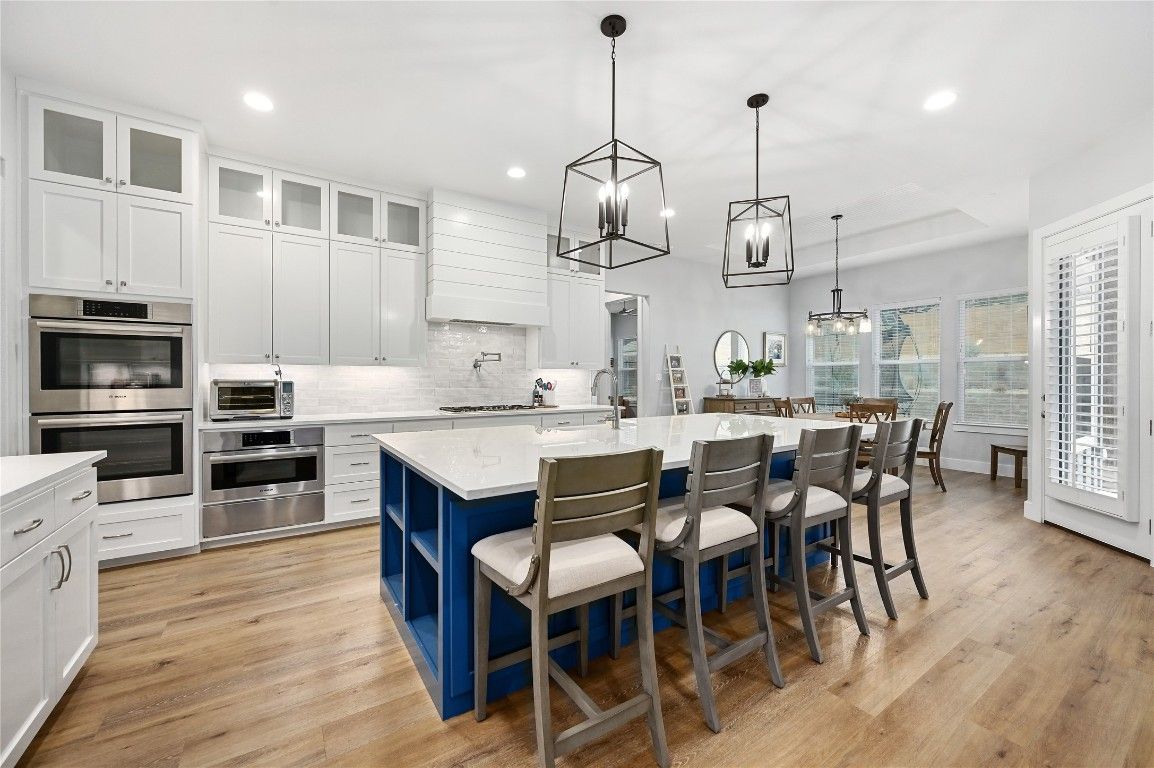 Dining room, Interior, Kitchen, Pendant Lights, Recessed Lighting, Stainless Steel Appliances, Wood Texture Flooring