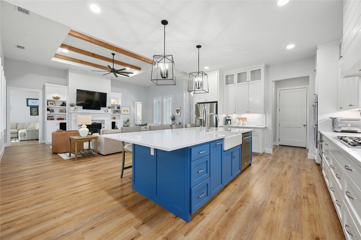 Fireplace, Interior, Kitchen, Living room, Pendant Lights, Recessed Lighting, Stainless Steel Appliances, Wood Texture Flooring