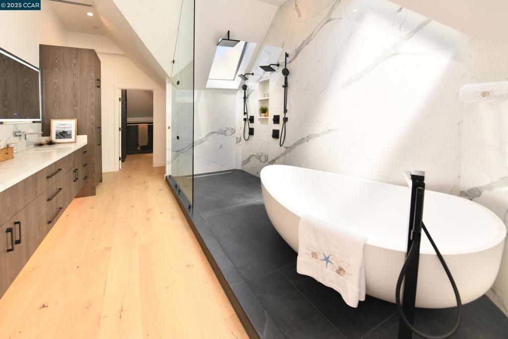 Bathroom, Free Standing Baths, Glass Shower, Interior, Marble Walls, Recessed Lighting, Wood Texture Flooring