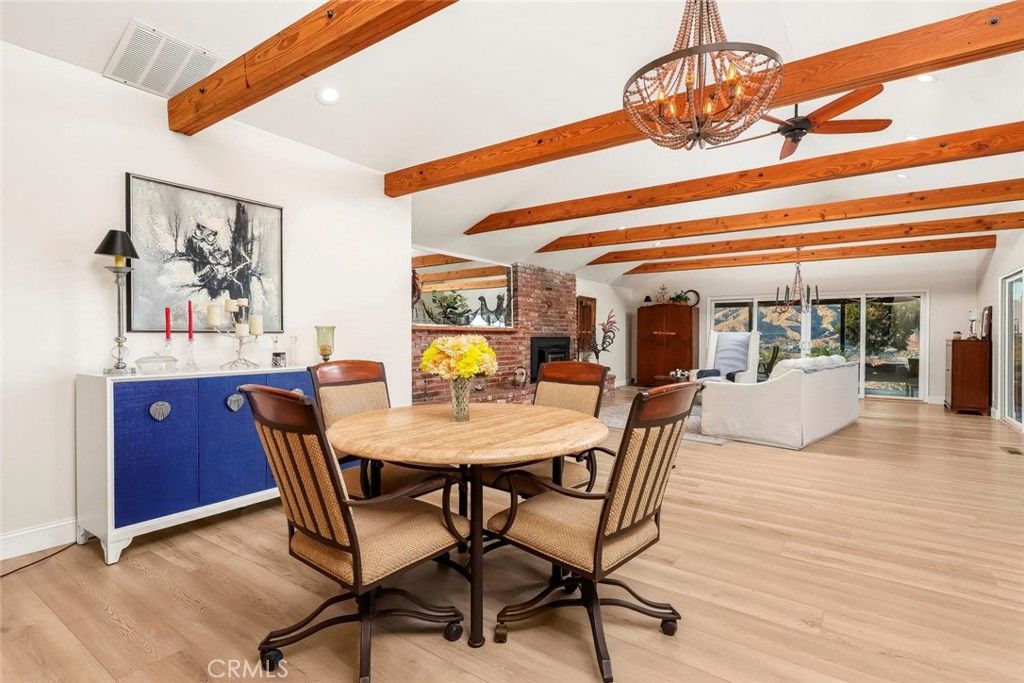 Chandelier, Dining room, Fireplace, Interior, Living room, Recessed Lighting, Stone Walls, Wooden Beams, Wood Texture Flooring