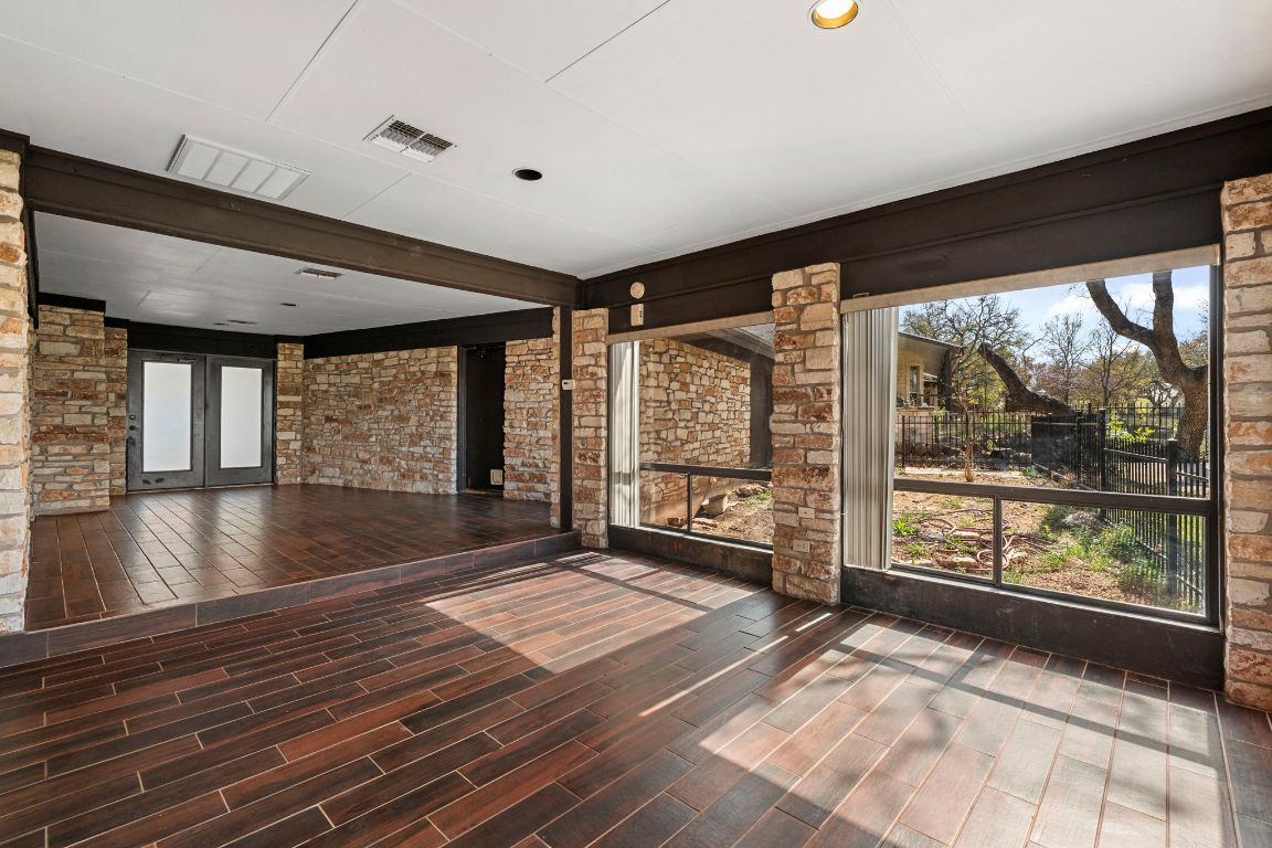 Empty room, Fireplace, Interior, Recessed Lighting, Stone Walls, Wood Texture Flooring