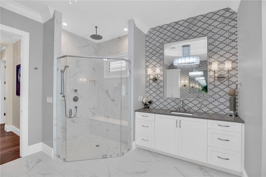 Bathroom, Chandelier, Glass Shower, Interior, Marble, Marble Walls, Recessed Lighting, Wood Texture Flooring