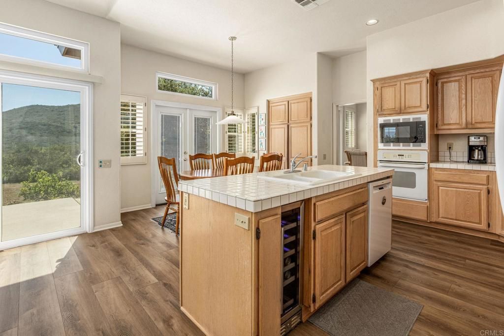 Dining room, Interior, Kitchen, Pendant Lights, Recessed Lighting, Tile Countertops, Wood Texture Flooring