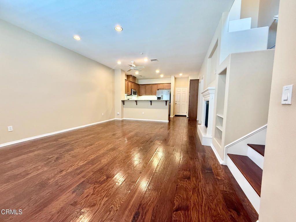 Empty room, Fireplace, Interior, Kitchen, Recessed Lighting, Wood Texture Flooring