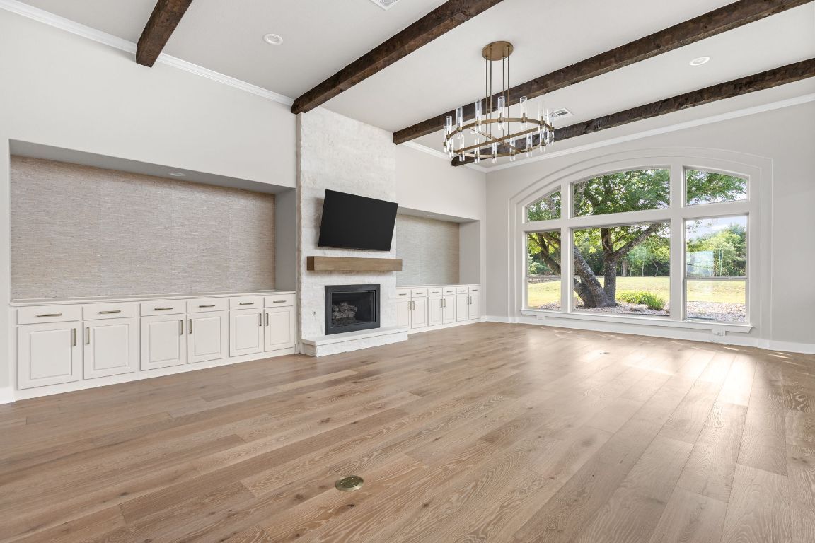 Chandelier, Empty room, Fireplace, Interior, Pendant Lights, Recessed Lighting, Wooden Beams, Wood Texture Flooring