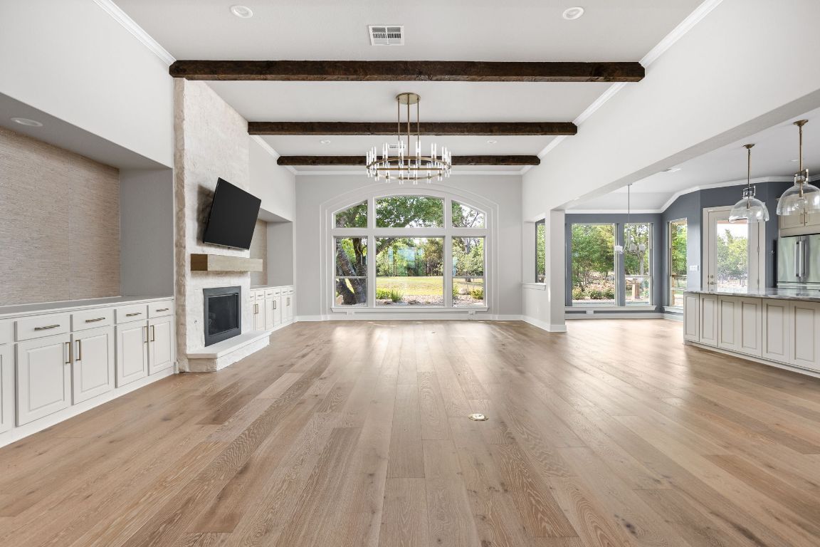 Chandelier, Empty room, Fireplace, Interior, Pendant Lights, Recessed Lighting, Wooden Beams, Wood Texture Flooring
