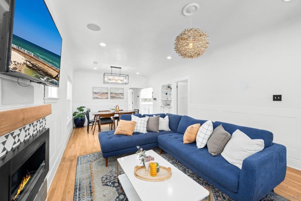 Chandelier, Dining room, Fireplace, Interior, Living room, Pendant Lights, Recessed Lighting, Wood Texture Flooring
