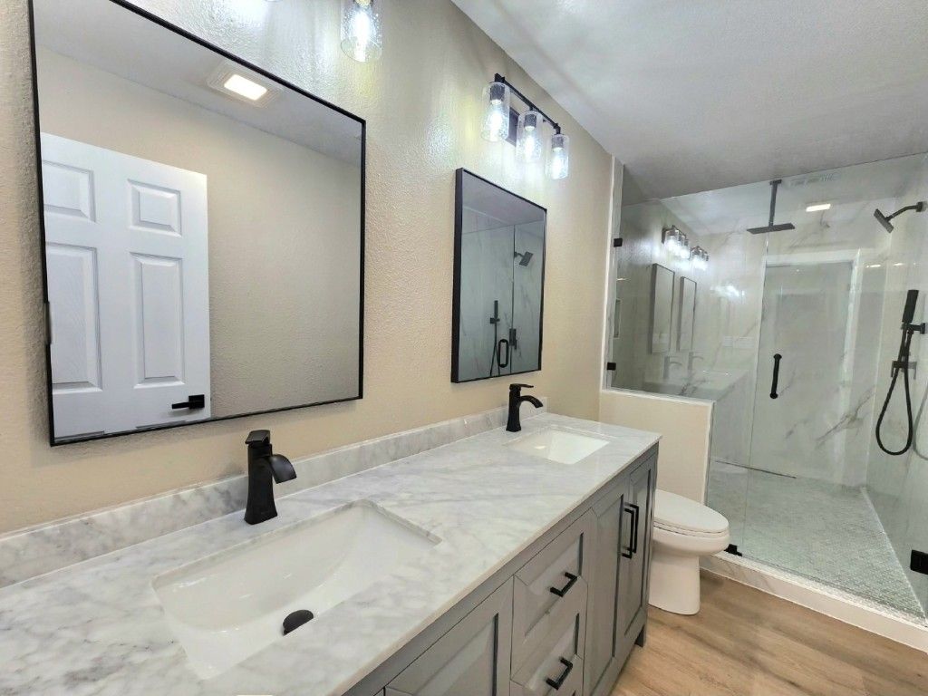 Bathroom, Dual Sink Vanities, Glass Shower, Interior, Marble Walls, Wood Texture Flooring