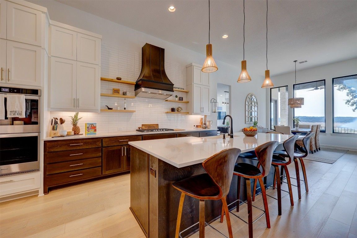Dining room, Interior, Kitchen, Pendant Lights, Recessed Lighting, Stainless Steel Appliances, Water, Wood Texture Flooring
