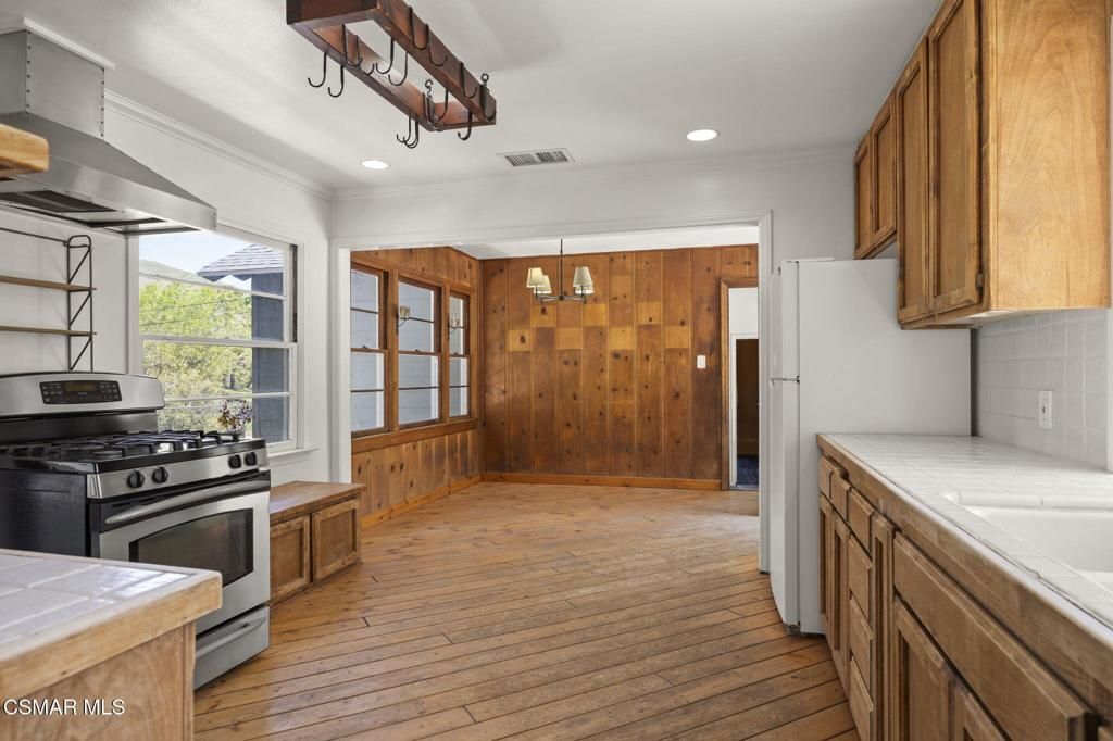 Interior, Kitchen, Pendant Lights, Recessed Lighting, Stainless Steel Appliances, Tile Countertops, Wood Texture Flooring