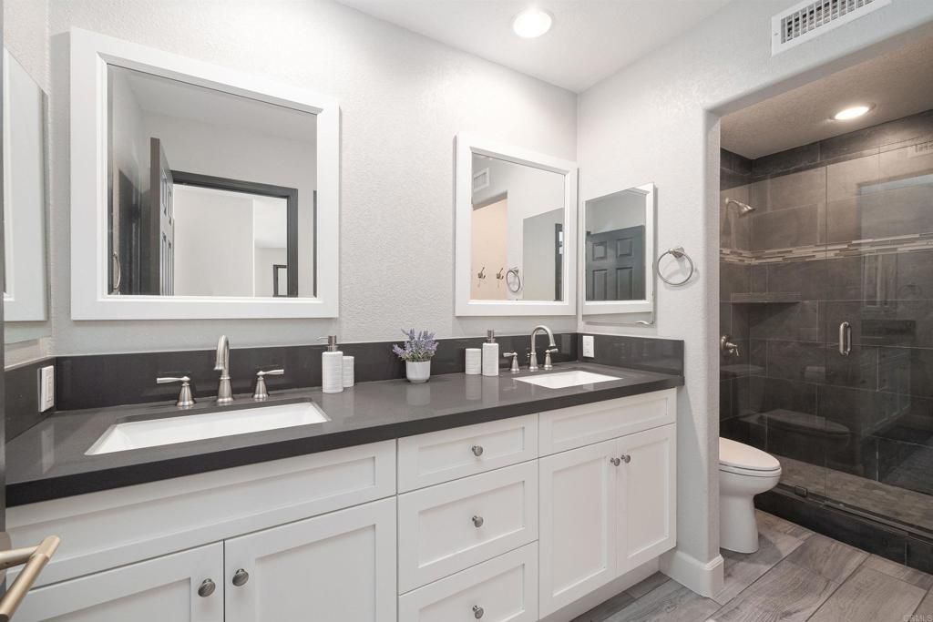 Bathroom, Dual Sink Vanities, Glass Shower, Interior, Recessed Lighting, Wood Texture Flooring