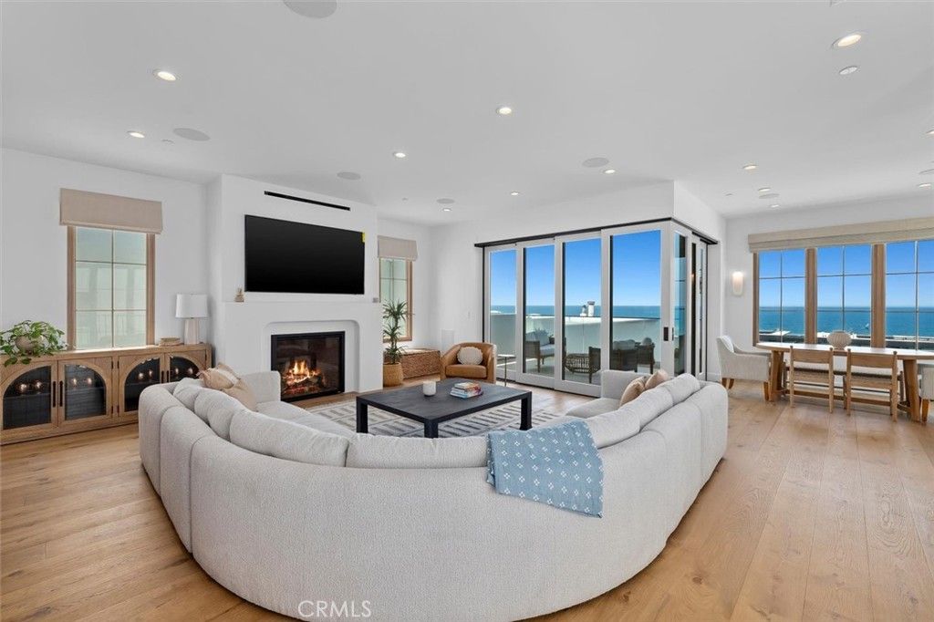 Dining room, Fireplace, Interior, Living room, Recessed Lighting, Water, Wood Texture Flooring