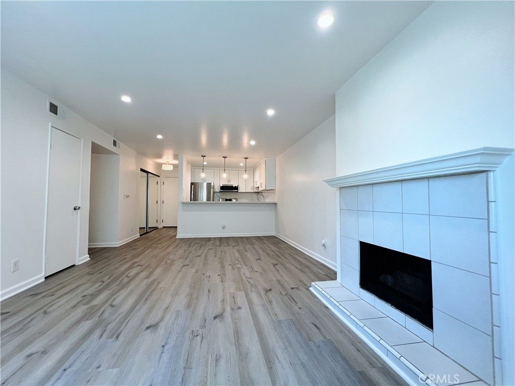 Empty room, Fireplace, Interior, Kitchen, Pendant Lights, Recessed Lighting, Wood Texture Flooring