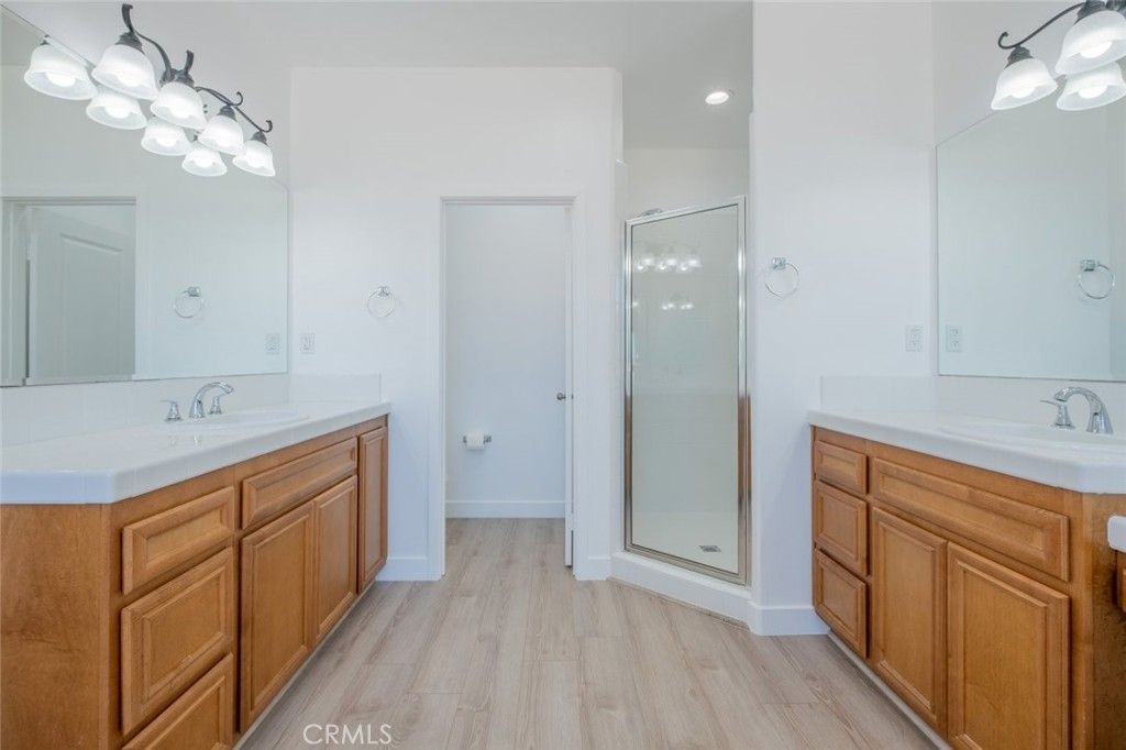 Bathroom, Dual Sink Vanities, Glass Shower, Interior, Recessed Lighting, Wood Texture Flooring