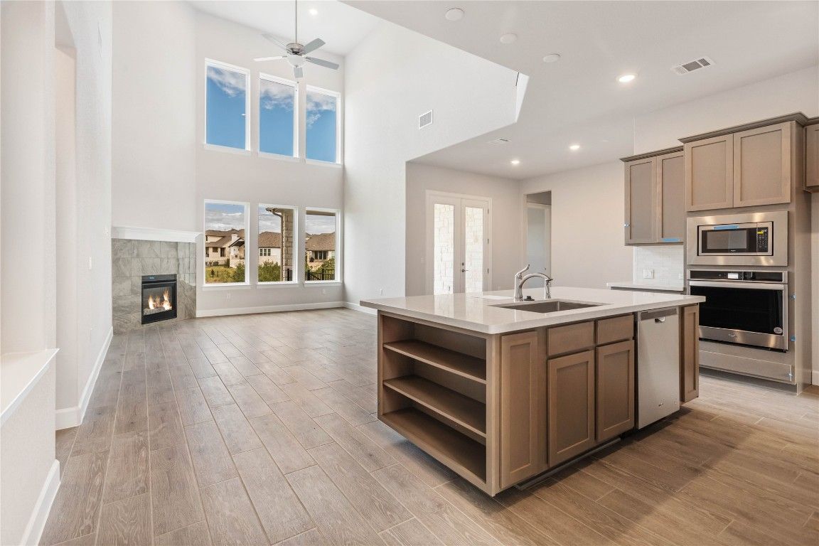Fireplace, Interior, Kitchen, Recessed Lighting, Stainless Steel Appliances, Wood Texture Flooring