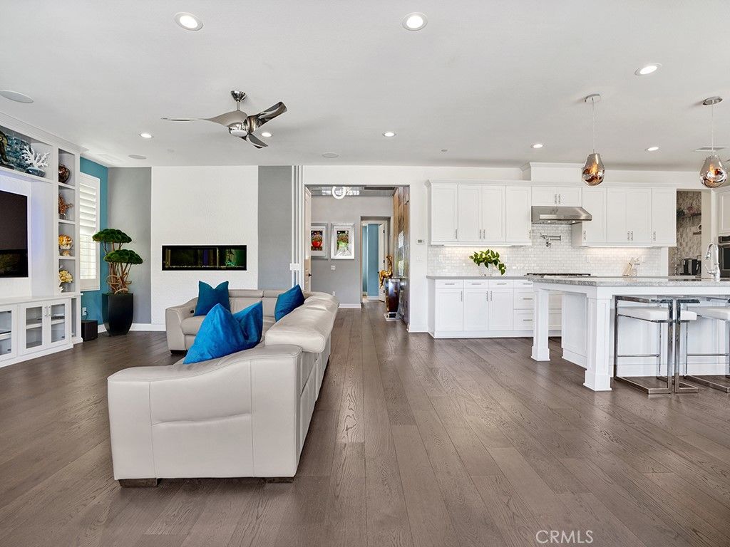 Fireplace, Interior, Kitchen, Living room, Pendant Lights, Recessed Lighting, Stainless Steel Appliances, Wood Texture Flooring