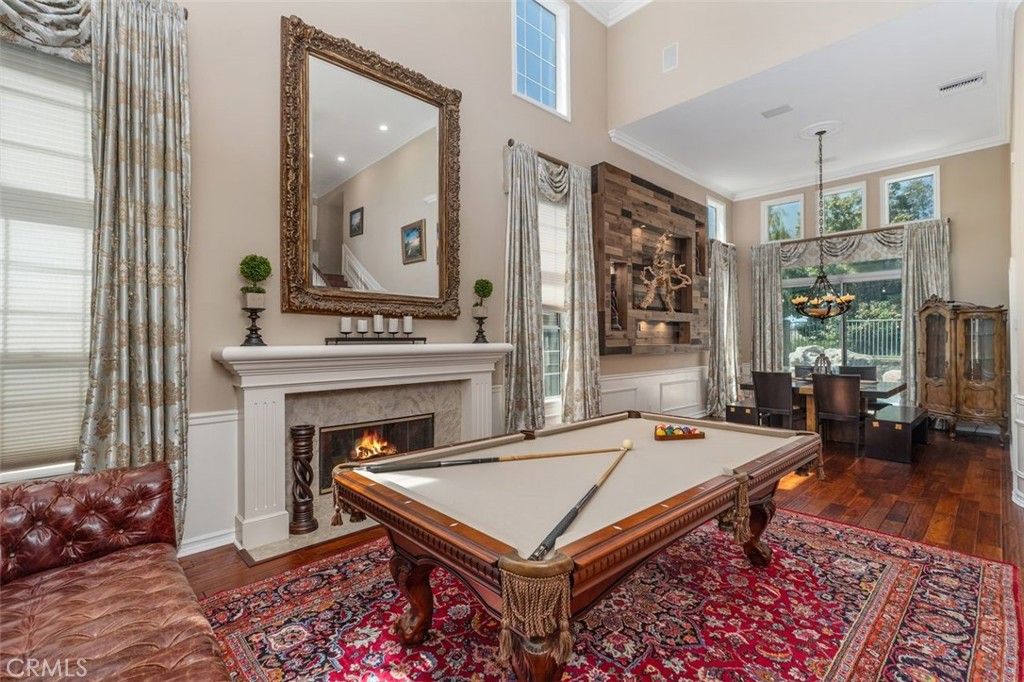 Billiard Table, Chandelier, Fireplace, Game Room, Interior, Pendant Lights, Recessed Lighting, Wood Texture Flooring