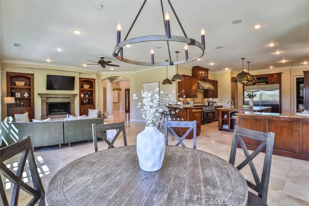 Chandelier, Dining room, Fireplace, Interior, Kitchen, Living room, Pendant Lights, Recessed Lighting, Stainless Steel Appliances