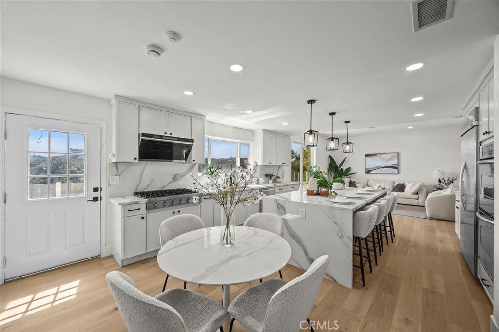 Dining room, Interior, Kitchen, Living room, Marble Walls, Pendant Lights, Recessed Lighting, Stainless Steel Appliances, Wood Texture Flooring