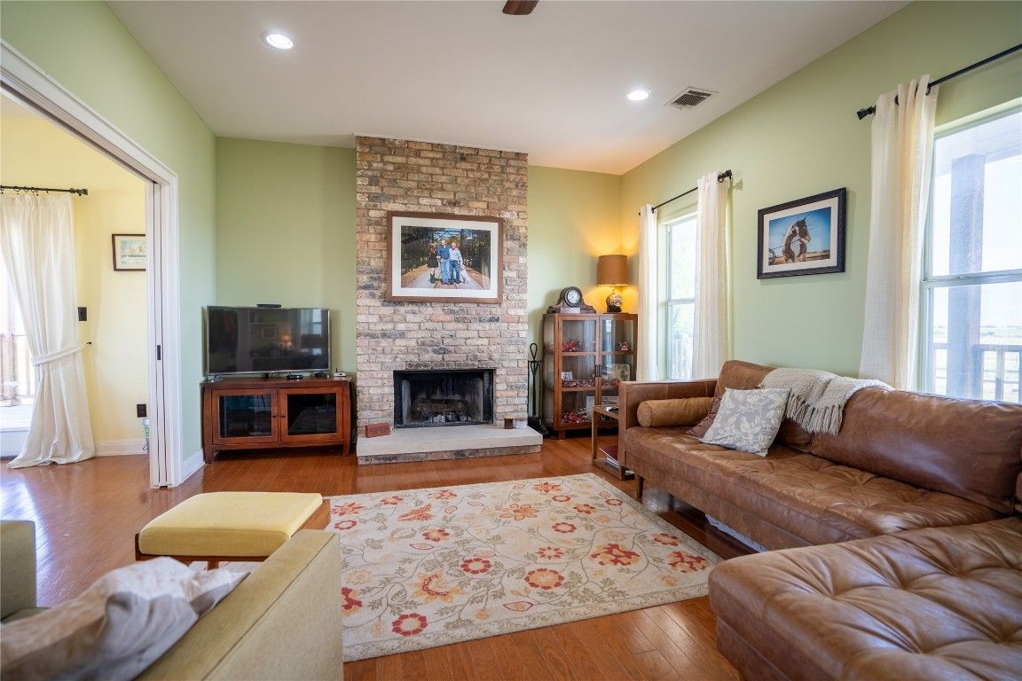 Fireplace, Interior, Living room, Recessed Lighting, Stone Walls, Wood Texture Flooring