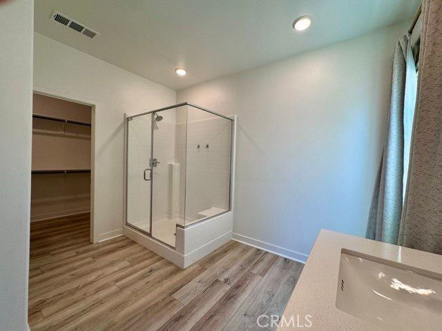 Bathroom, Glass Shower, Interior, Recessed Lighting, Walk-in Closets, Wood Texture Flooring