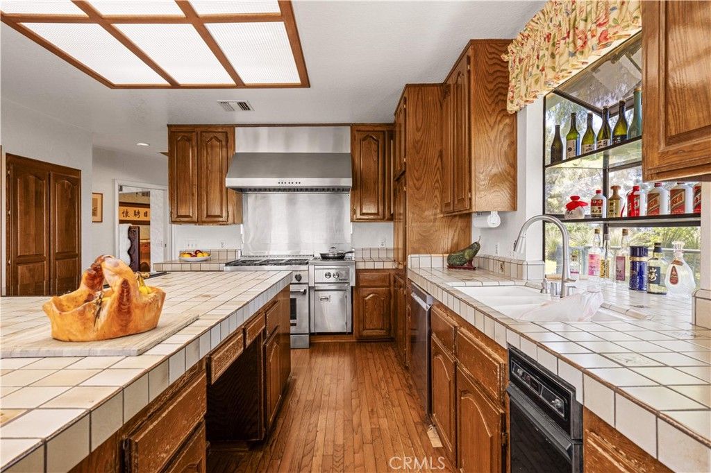 Interior, Kitchen, Recessed Lighting, Stainless Steel Appliances, Tile Countertops, Wood Texture Flooring