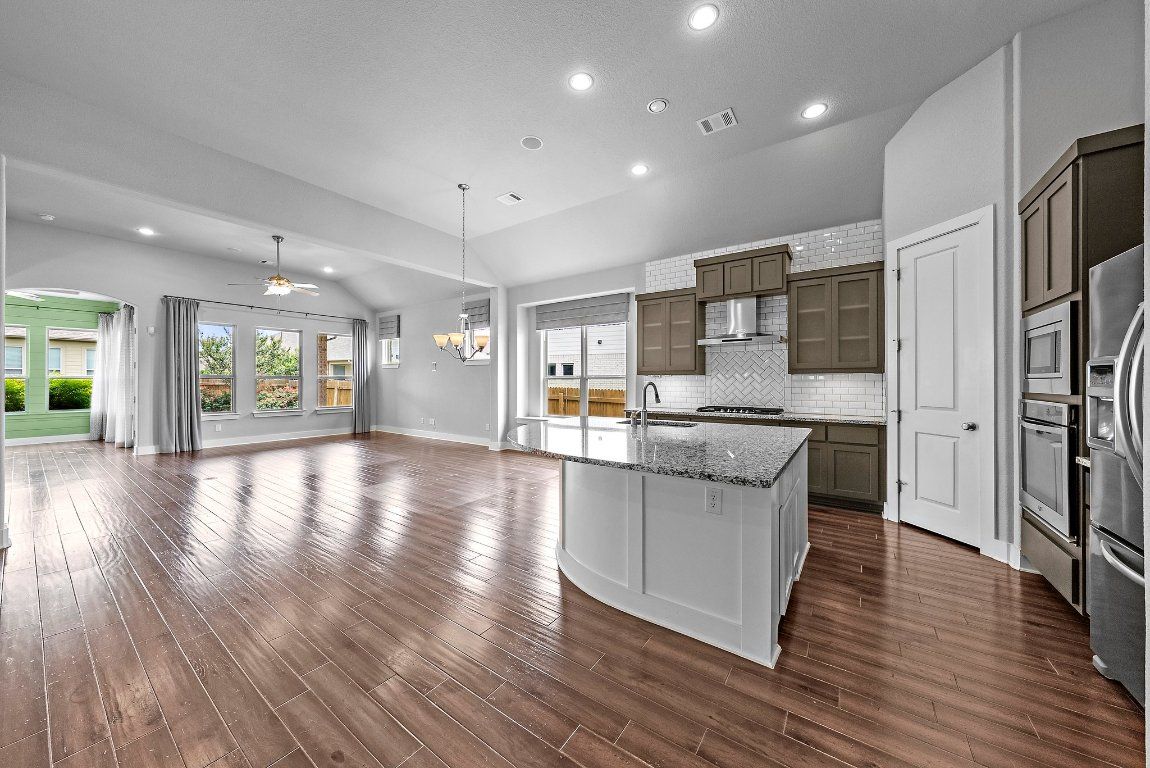 Chandelier, Empty room, Interior, Kitchen, Pendant Lights, Recessed Lighting, Stainless Steel Appliances, Wood Texture Flooring