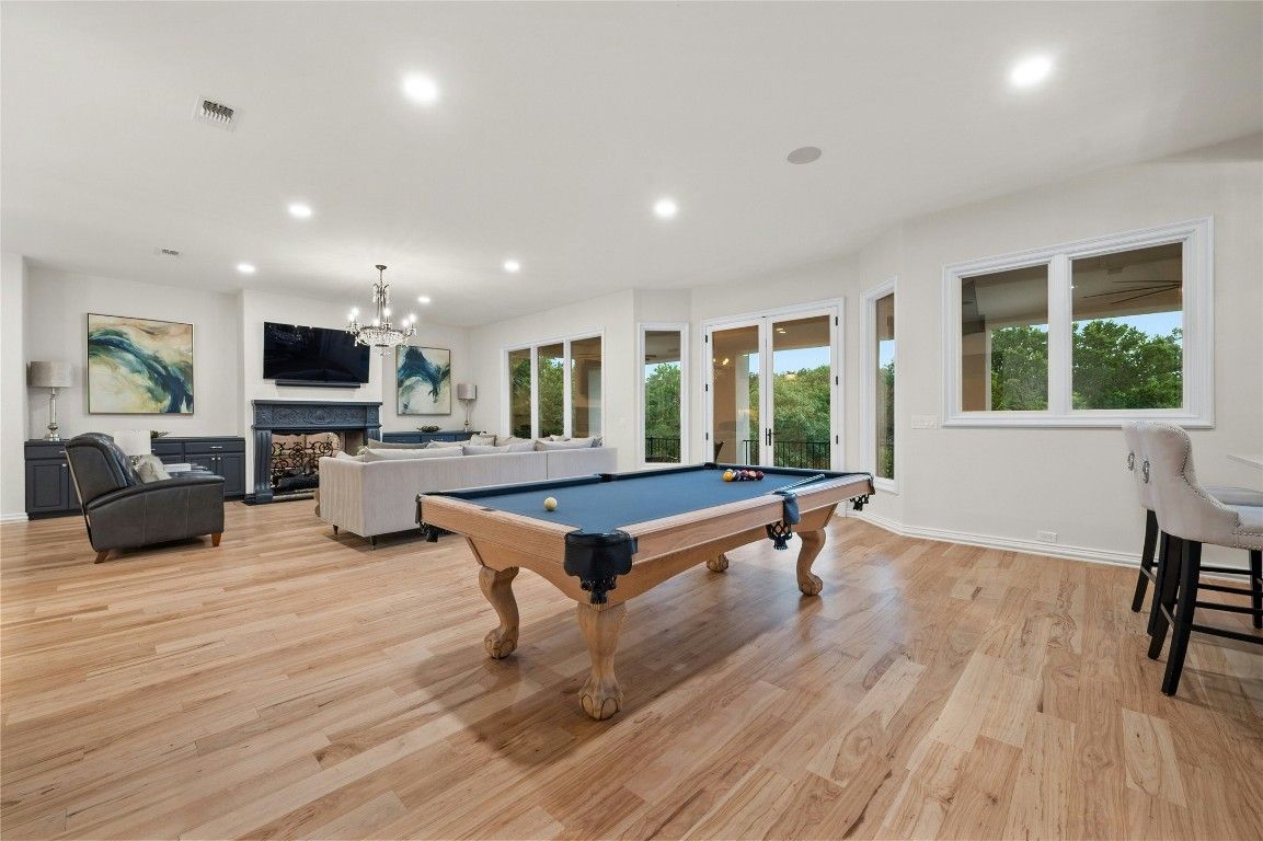 Billiard Table, Chandelier, Fireplace, Game Room, Interior, Living room, Recessed Lighting, Wood Texture Flooring