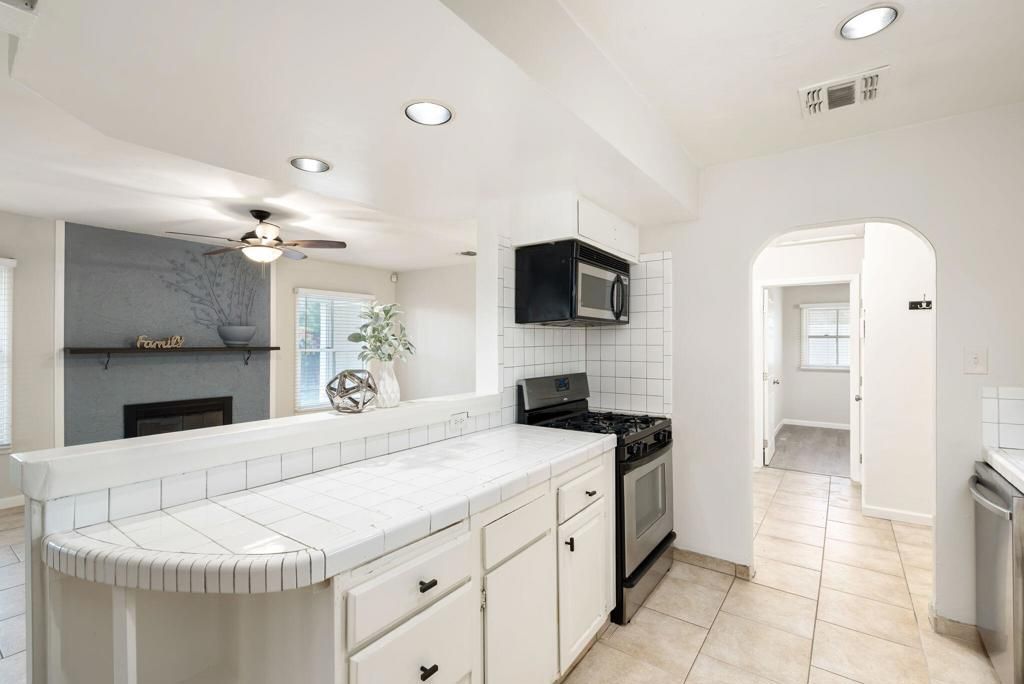 Fireplace, Interior, Kitchen, Recessed Lighting, Tile Countertops