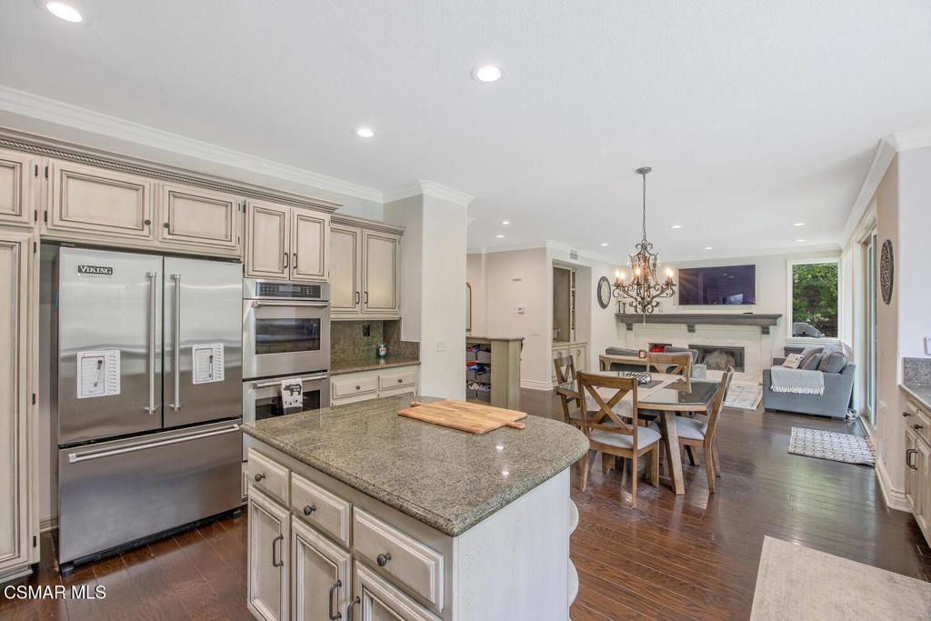 Chandelier, Dining room, Fireplace, Interior, Kitchen, Living room, Recessed Lighting, Stainless Steel Appliances, Wood Texture Flooring