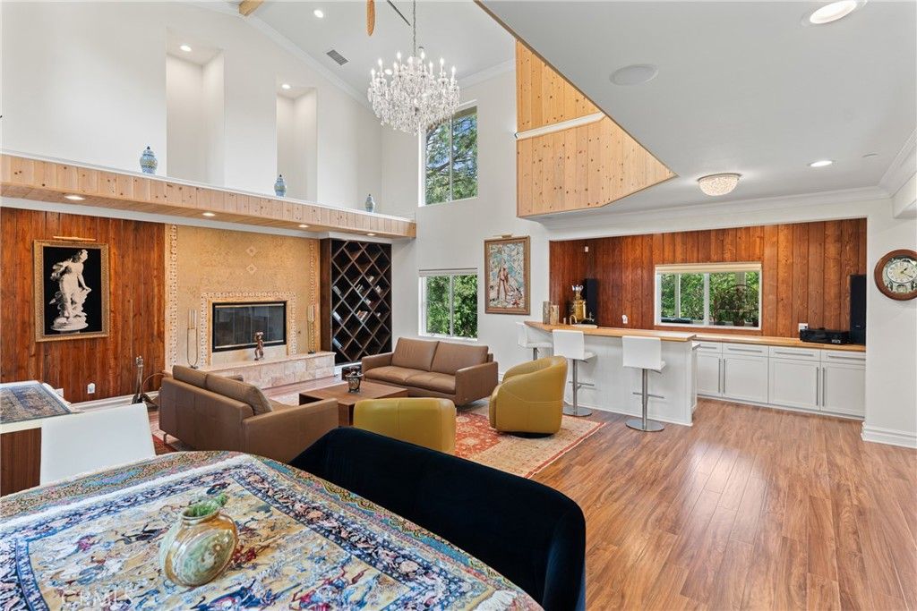 Chandelier, Fireplace, Interior, Living room, Recessed Lighting, Wood Texture Flooring, Wooden Walls