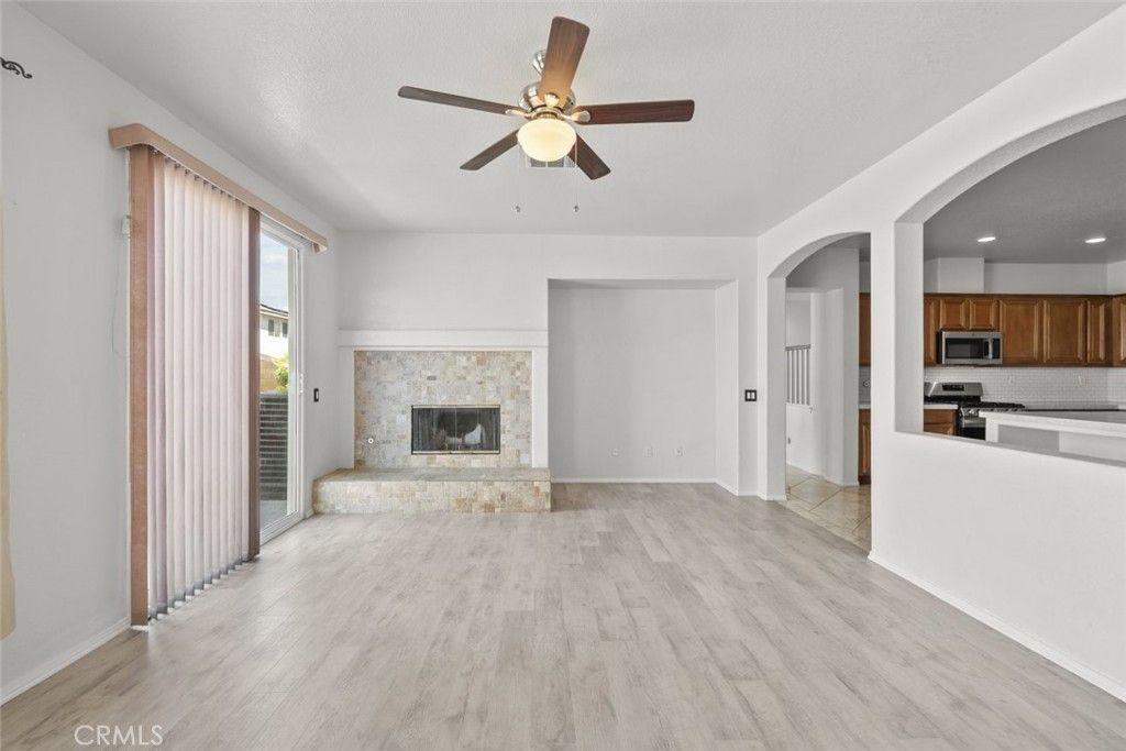 Empty room, Fireplace, Interior, Kitchen, Recessed Lighting, Stainless Steel Appliances, Wood Texture Flooring