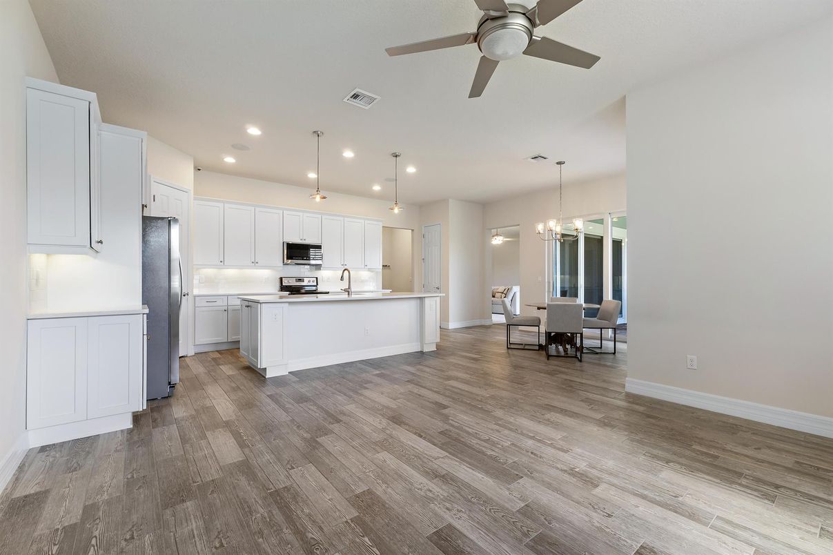 Dining room, Interior, Kitchen, Pendant Lights, Recessed Lighting, Stainless Steel Appliances, Wood Texture Flooring