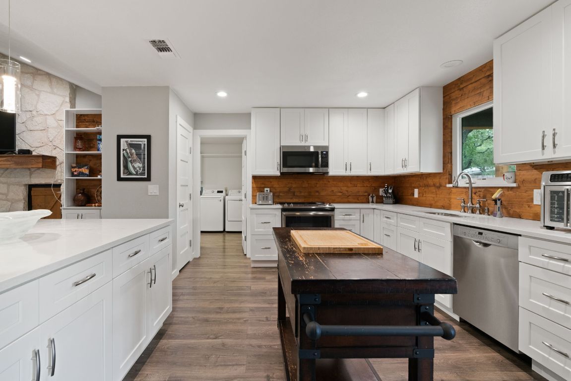 Fireplace, Interior, Kitchen, Recessed Lighting, Stainless Steel Appliances, Stone Walls, Wood Texture Flooring