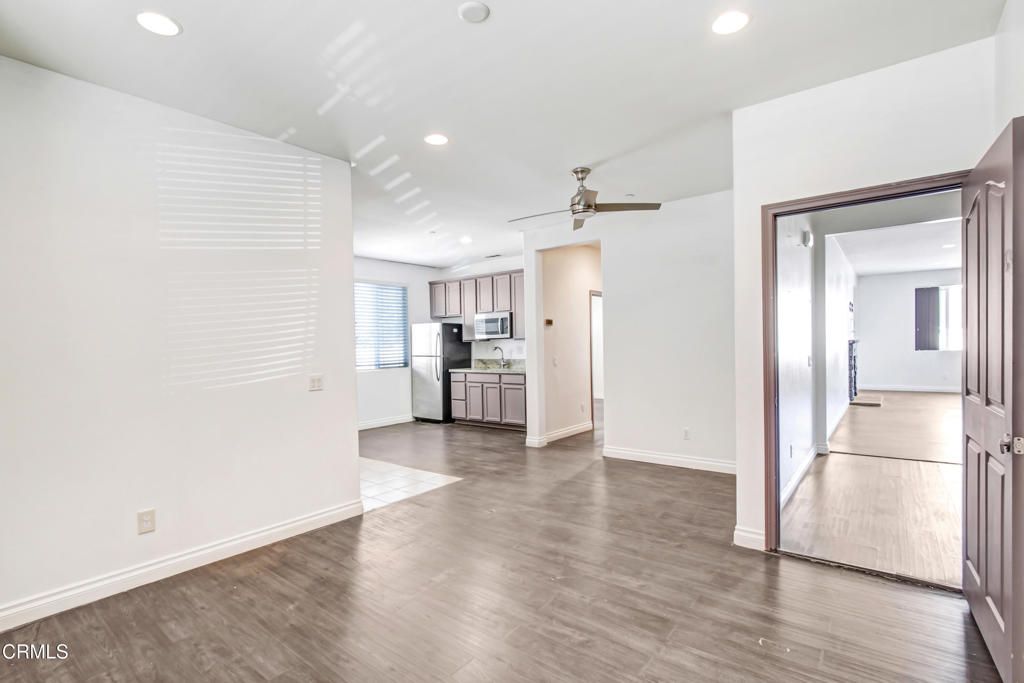 Empty room, Interior, Kitchen, Recessed Lighting, Stainless Steel Appliances, Wood Texture Flooring