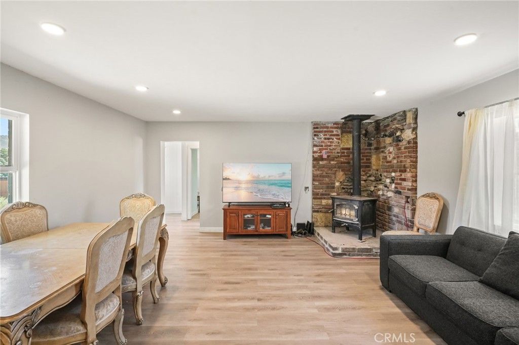 Dining room, Fireplace, Interior, Living room, Recessed Lighting, Stone Walls, Wood Texture Flooring