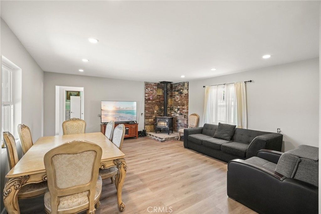Dining room, Fireplace, Interior, Living room, Recessed Lighting, Stone Walls, Wood Texture Flooring