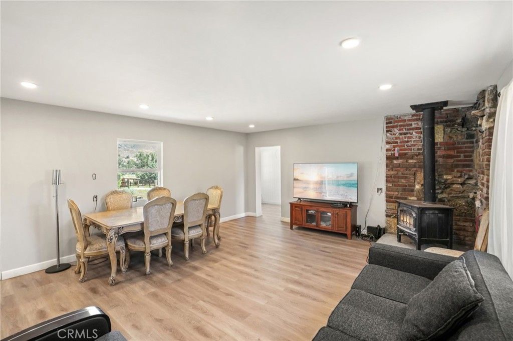 Dining room, Fireplace, Interior, Living room, Recessed Lighting, Stone Walls, Wood Texture Flooring