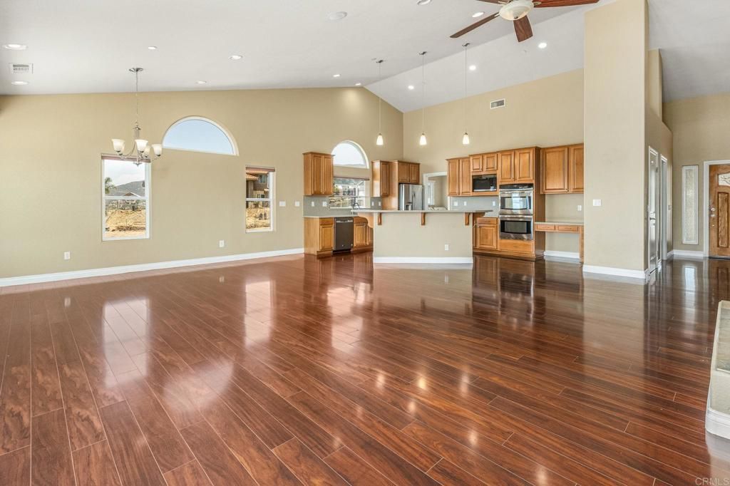Chandelier, Empty room, Interior, Kitchen, Pendant Lights, Recessed Lighting, Stainless Steel Appliances, Wood Texture Flooring