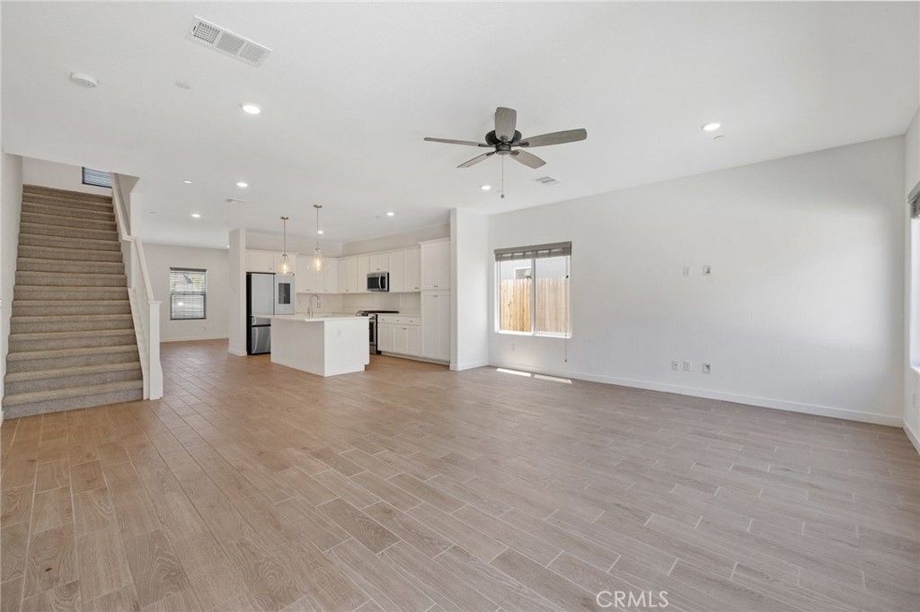 Empty room, Interior, Kitchen, Pendant Lights, Recessed Lighting, Stainless Steel Appliances, Wood Texture Flooring