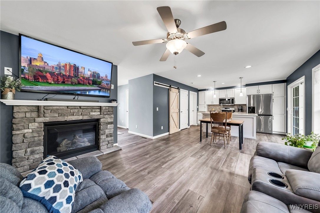 Dining room, Fireplace, Interior, Kitchen, Living room, Pendant Lights, Recessed Lighting, Stainless Steel Appliances, Wood Texture Flooring