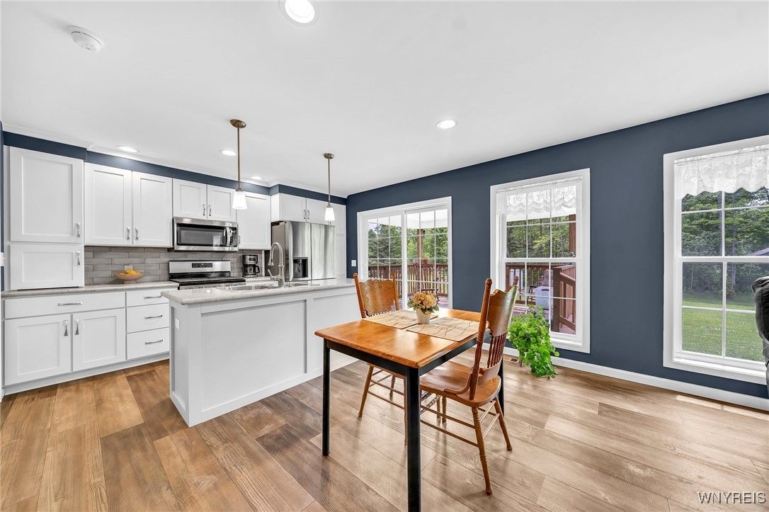 Dining room, Interior, Kitchen, Pendant Lights, Recessed Lighting, Stainless Steel Appliances, Wood Texture Flooring