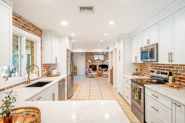 Fireplace, Interior, Kitchen, Recessed Lighting, Stainless Steel Appliances, Stone Walls