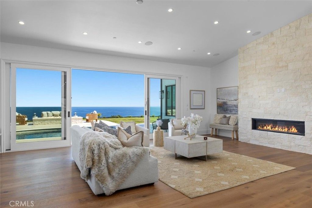 Fireplace, Interior, Living room, Recessed Lighting, Stone Walls, Water, Wood Texture Flooring