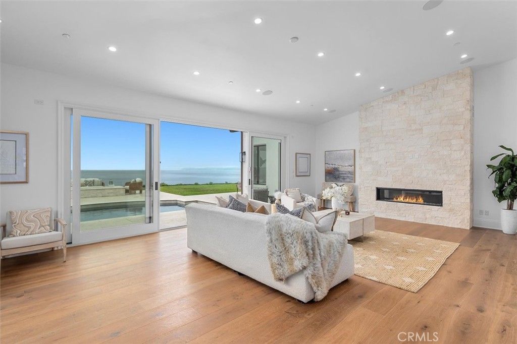 Fireplace, Interior, Living room, Recessed Lighting, Stone Walls, Water, Wood Texture Flooring