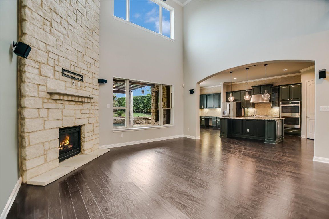Fireplace, Interior, Kitchen, Pendant Lights, Recessed Lighting, Stainless Steel Appliances, Stone Walls, Wood Texture Flooring