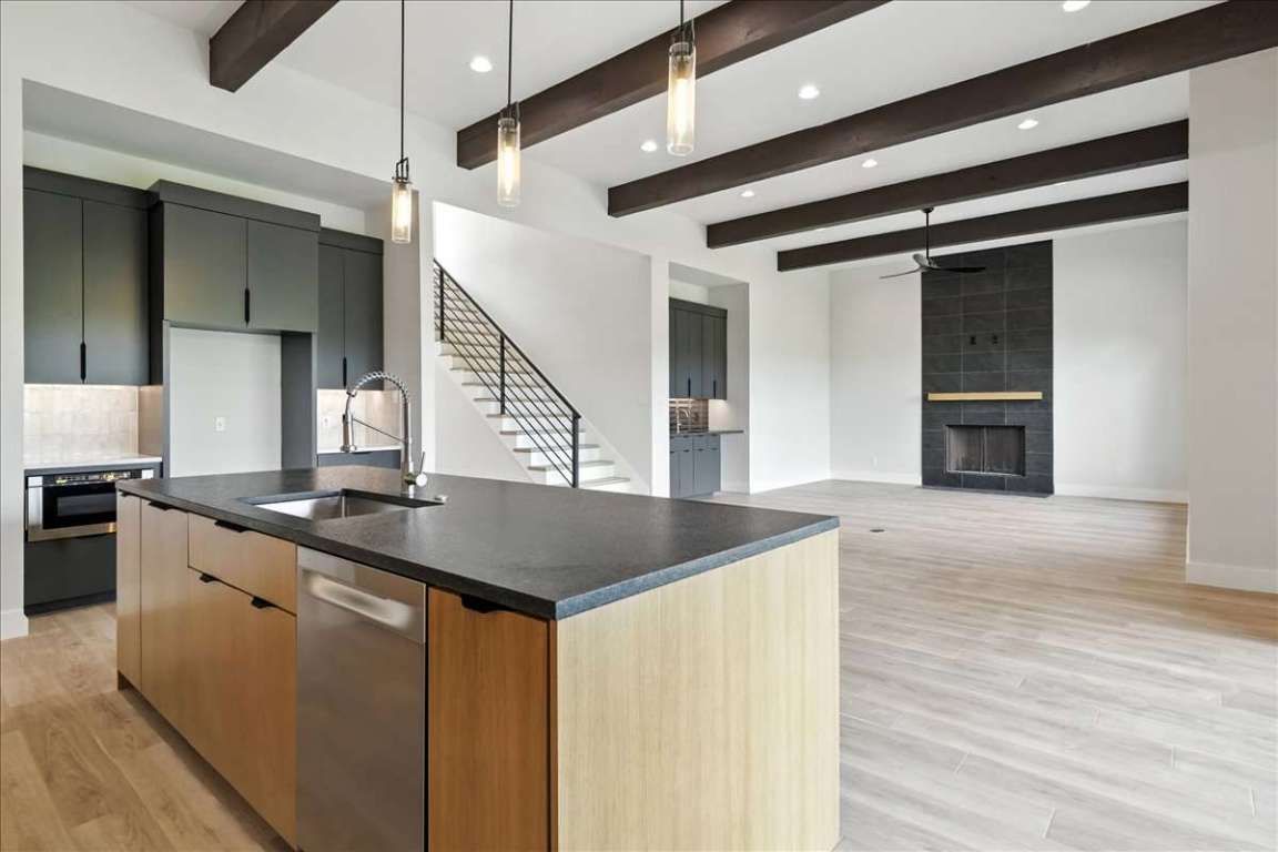 Fireplace, Interior, Kitchen, Pendant Lights, Recessed Lighting, Stainless Steel Appliances, Wooden Beams, Wood Texture Flooring
