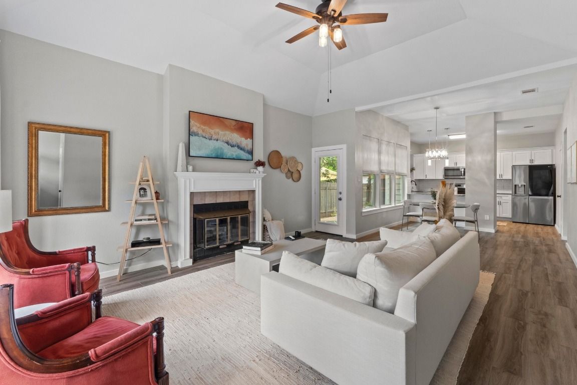 Chandelier, Fireplace, Interior, Kitchen, Living room, Pendant Lights, Stainless Steel Appliances, Wood Texture Flooring