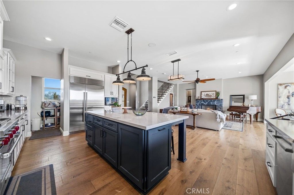 Fireplace, Interior, Kitchen, Living room, Pendant Lights, Recessed Lighting, Stainless Steel Appliances, Wood Texture Flooring