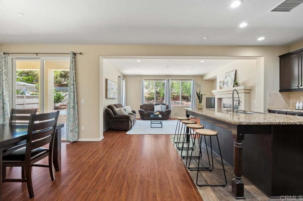 Dining room, Fireplace, Interior, Living room, Recessed Lighting, Wood Texture Flooring